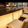 Bar front in ViviStone Honey Onyx glass shown in backlit View configuration with